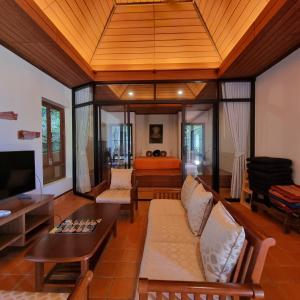 a living room with a couch and a table at The Great Escape Pool Seaview Villa in Ko Lanta