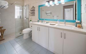 a bathroom with a sink and a toilet and a mirror at Maltese Falcon - by ZenBreak in Saint Philip