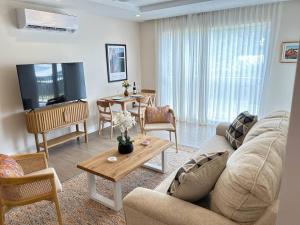 een woonkamer met een bank en een tafel bij Coral Beach 204 - by ZenBreak in Saint Peter +11 foto's