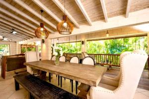 a dining room with a wooden table and chairs at Kyalami - by ZenBreak in Saint James