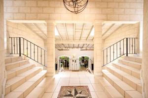 a lobby of a building with stairs and a chandelier at Kyalami - by ZenBreak in Saint James