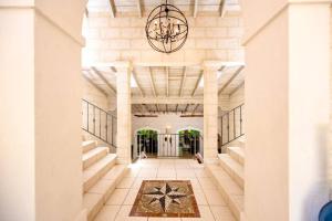 a hallway of a building with a chandelier at Kyalami - by ZenBreak in Saint James