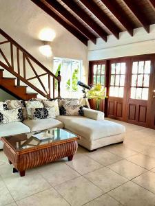 a living room with a couch and a coffee table at Harbour View - by ZenBreak in Saint Michael