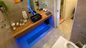 a bathroom with a shower with a wooden counter top at Villa De Lasannta - by ZenBreak in Christ Church