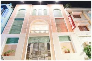 ein Gebäude mit vielen Fenstern und einem Schild darauf in der Unterkunft Hotel S-Swastik Residency Near Jagannath Temple and Sea Beach - Fully Air Conditioning Rooms - Free Wifi and Room Service - Best Premium Hotel In Puri in Puri