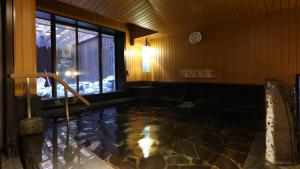 a swimming pool in a room with a clock on the wall at Dormy Inn Sendai Annex in Sendai +92 photos