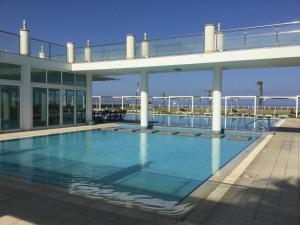 a large swimming pool on top of a building at Aphrodite Beachfront Apartment in Ghaziveran