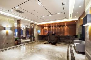 a lobby with a reception desk in a building at Yitel Collection Shenyang North Railway Station Metro Station in Shenyang