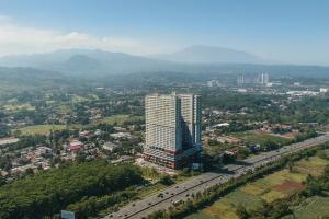 an aerial view of a tall building in a city at Ignis by KolivHub I Studio I Sentul in Kedungmanggu