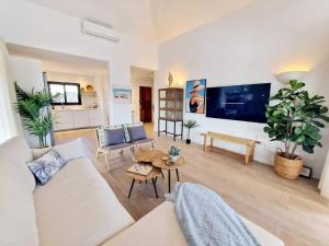a living room with a couch and a table at Costa Christina con piscina climatiza in Yaiza +17 photos