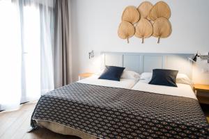 a hotel room with two beds in a room at Los Cardones Boutique Village in Playa de las Americas