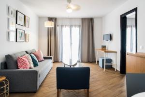 a living room with a couch and a table at Los Cardones Boutique Village in Playa de las Americas