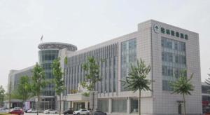 a large office building with a tower on top of it at GreenTree Inn Tianjin Wuqing Distric Bohai Market in Dadunqiu