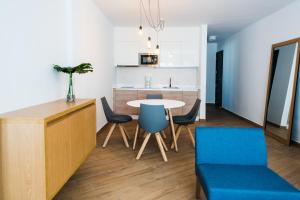 a kitchen and dining room with a table and chairs at Los Cardones Boutique Village in Playa de las Americas