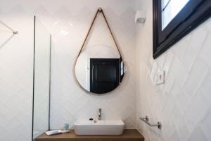 a bathroom with a sink and a mirror on the wall at Los Cardones Boutique Village in Playa de las Americas