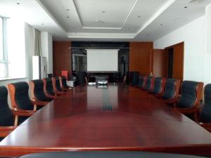 a large conference room with a large table and chairs at GreenTree Inn Shanghai Changxing Island Yuansha Fishing Port Hotel in Yuansha