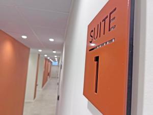 a hallway with a exit sign on a wall at NUEVO -Bogotá Suites- Apartamentos con cocina, AC, 15min del centro a pie in Alicante