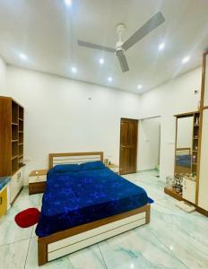 a bedroom with a bed with a blue comforter at Zonooro Homestay Vythiri in Vythiri