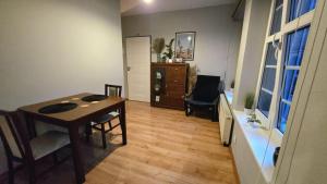a living room with a table and a chair at 4 Lions Guest House in Gdańsk