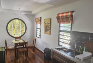 a kitchen with a sink and a table and a window at "FLORIDA" - Guest-house Tamatave in Toamasina