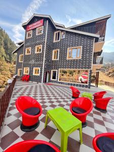 a building with red and green tables and chairs at Raj Hotel and Restaurant in Bhadarwāh