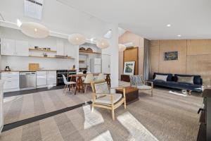 a kitchen and living room with a table and chairs at Wombat Pavilion in Yanakie