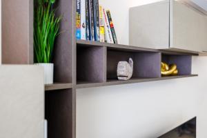 a room with a book shelf with books at Stylish 2BR Retreat, Central Location, Few Steps from the Sea by QuickTrips in Marsaskala