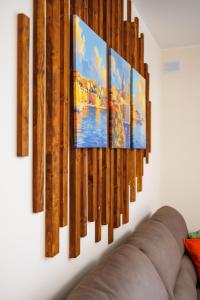 a group of paintings hanging on a wall at Stylish 2BR Retreat, Central Location, Few Steps from the Sea by QuickTrips in Marsaskala