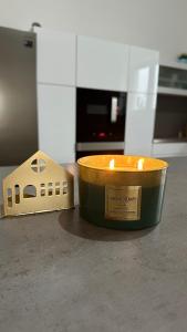 a candle and a toy house on a counter at Apartmán 135 in Trutnov