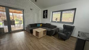 a living room with a couch and a table and chairs at Apartmán 135 in Trutnov +48 photos