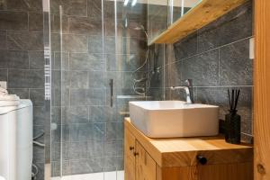 een badkamer met een wastafel en een douche bij HelloCHALET TrackSide House - Ski-In Ski-Out Apartment on the Cretaz Slopes in Breuil-Cervinia