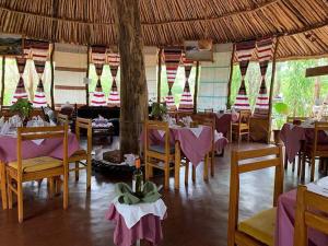 TurmiBusca Lodge的餐厅配有桌椅和紫色桌布 更多52张照片