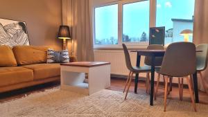 a living room with a couch and a table and chairs at PAE korter Kärdlas in Kärdla +7 photos