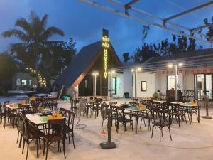 a group of tables and chairs in front of a building at BeanHomestay in Quang Ninh