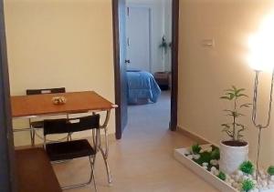 a room with a desk and a table with a plant at Maple homes in Kammasandra