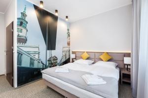 a bedroom with a bed with a view of a city at Meet Poznań Hotel in Poznań