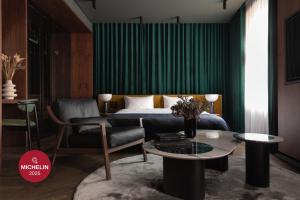 a bedroom with a bed and a chair and a table at A22 Hotel in Rīga