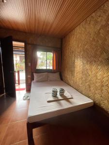 En eller flere senge i et værelse på Akoya Beach Park and Cottages - El Nido