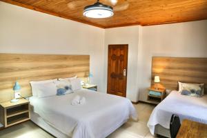 En eller flere senge i et værelse på Tuscany Vryburg