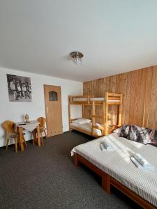 a bedroom with a bunk bed and a table at AgroDomek Rzepiska in Rzepiska +116 photos