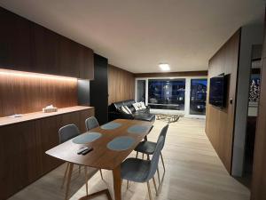 een keuken en eetkamer met een tafel en stoelen bij Mountain Loft - DuLac 33 in St. Moritz