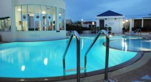 a large blue swimming pool in a hotel at River City Hotel in Mukdahan