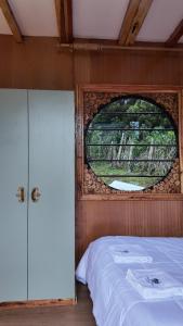 een slaapkamer met een groot raam en een bed bij O-Frame by WildFoot in Kabaru