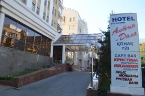 un hotel con un cartello di fronte a un edificio di Altyn Dala Hotel a Astana