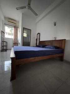 a bedroom with a wooden bed in a room at Lanka Hotel in Mirissa