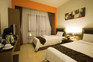 Postel nebo postele na pokoji v ubytování Grand Malioboro Yogyakarta + 209 fotografií