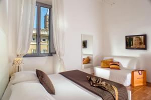 a bedroom with two beds and a cat laying on a table at Domus Liberius - Rome in Rome