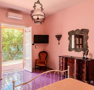 a room with a table and a mirror and a chair at Villa Scarpariello Relais in Ravello