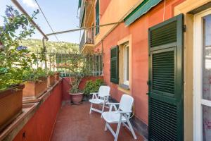 a patio with two chairs and a table on a building at Casa Vacanze Belvedere in Santa Margherita Ligure