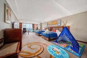 a bedroom with two beds and a tent in it at Dandong Xin An Dong Hotel in Dandong +223 photos